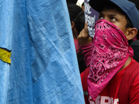 A protester wearing a kerchief as a mask is seen during a rally in Manila, Philippines coinciding the Association of Southeast Asian Nations...