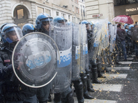 Italian  riot police officers stand guard after receiving some eggs on their uniform, during the May Day celebration  (