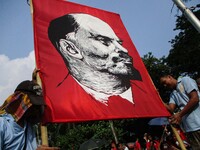Filipino workers prop up a portrait of Russian revolutionary Vladimir Lenin during a rally in Manila, Philippines on International Labor Day...