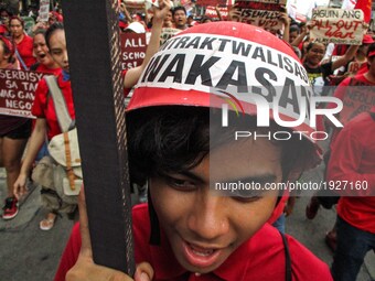 A protester wearing a mock safety hat with the words, 