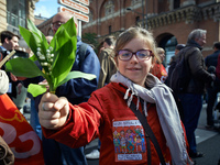 A girl shows lilys of the valley. More than 10 000 people took to the streets for the rally of May Day in Toulouse, France, on 1st May 2017....