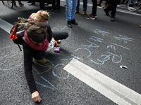 A woman writes on the ground 'Nor Macron, nor Le Pen'. Macron and Le Pen are the two finalists of the French presidential election. More tha...