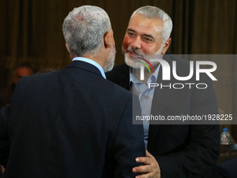Hamas leader Ismail Haniyeh (R) kisses Hamas Gaza Chief Yehya Al-Sinwar during a ceremony announcing a new policy document, in Gaza City May...