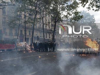 Police forces withstand Black Bloc fireworks thrown at them during the 1st of May marches  in Paris on May, 1th, 2017.

Framed between the...
