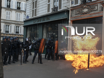 Police forces withstand a cocktail molotov thrown at them by Black Block protesters during the 1st of May marches  in Paris on May, 1th, 201...