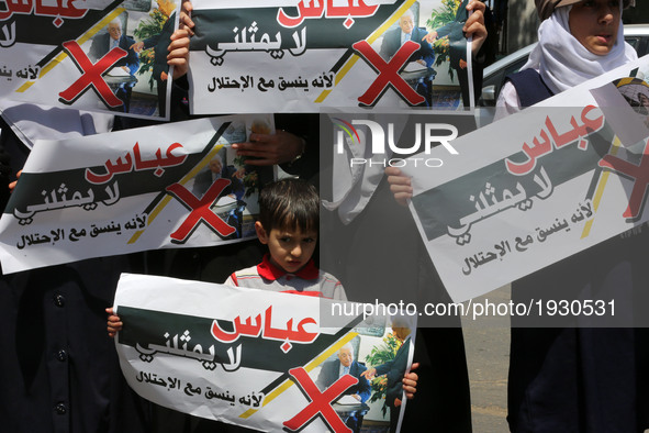  Palestinian kids hold signs as supporters of Hamas, Jihad Islamic and Al Ahrar movement gather to protest against President of the State of...