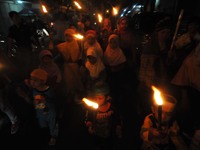 SURAKARTA, CENTRAL JAVA, INDONESIA - July 27: Indonesian muslims bring a torch and read sentences 