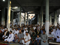 Palestinians hold their Eid al-Fitr prayers at al-Faruq Mosque a which was destroyed the week before in an Israeli military strike on Rafah,...