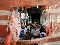 Palestinians hold their Eid al-Fitr prayers at al-Faruq Mosque a which was destroyed the week before in an Israeli military strike on Rafah,...