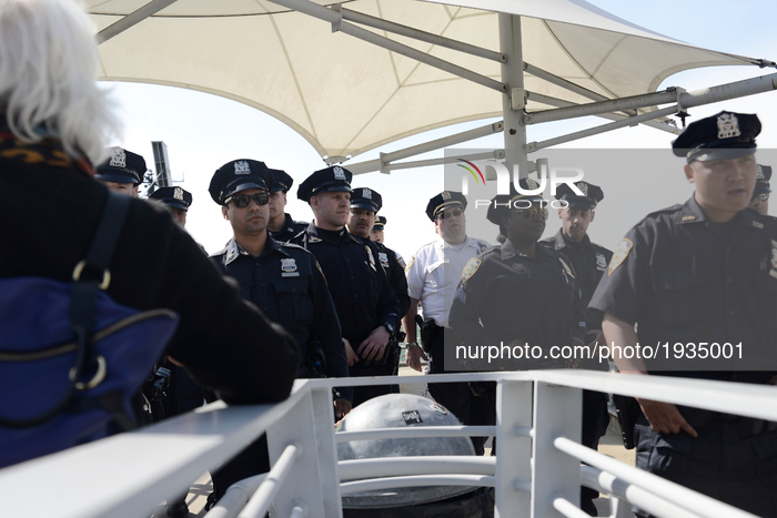 NYPD Police officers clear a pedestrian bridge ahead of a visit of US President Donald Trump to the USS Intrepid in New York city, NY, on Ma...