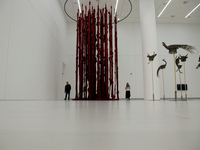 People walk below the art work of Cecilia Vicuna at the exhibition of documenta 14,  at EMST the National Museum of Contemporary Art, in Ath...