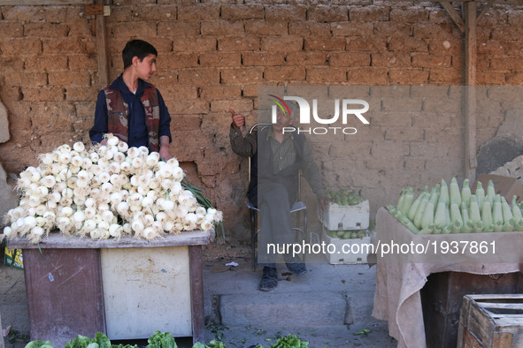 Syrian men vendors in the rebel-held town of Douma, on the eastern outskirts of the Syrian capital Damascus, on 6 May 2017 after the signing...