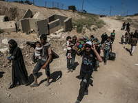 Civilians flee from Musharifah-2 neighborhood in Mosul as fighting between Iraqi forces and the Islamic State intensifies. Both the Ninth Di...