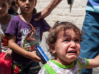 9-	A Palestinian girl cries after hearing a near by explosion during the Eid Al Fitr  celebrations at the Church of Saint Porphyrios in Gaza...