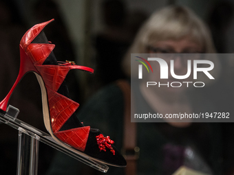 Visitors look at exhibits during the opening exhibition 'Manolo Blahnik. The Art of Shoes' at the Hermitage State Museum in St. Petersburg,...