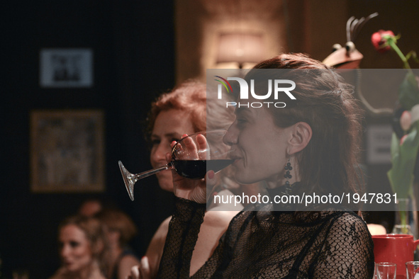 A lady with a coup of red wine between two Argentine tango dances during an afterparty event in Klub Cabaret, an event that was a part of Kr...