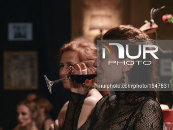 A lady with a coup of red wine between two Argentine tango dances during an afterparty event in Klub Cabaret, an event that was a part of Kr...