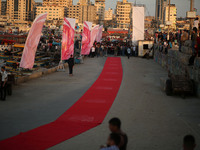 Palestinians place a red carpet during the Red Carpet Festival of Human Rights Films in the Gaza Port in Gaza City on May 12, 2017.
 (