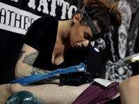 An artist works on a man during Athens's International Tatoo Convention, at the Olympic Tae Kwon Do Centre, on Saturday May 13, 2017. The vi...
