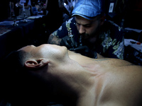An artist works on a man during Athens International Tatoo Convention, at the Olympic Tae Kwon Do Centre, on Saturday May 13, 2017. The visi...