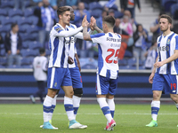 Porto's Portuguese forward Andre Silva celebrates after scoring goal with teammate Porto's Brazilian midfielder Otavio during the Premier Le...