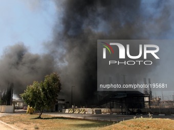  	Smoke and flames rise from the Gaza power plant after it was hit by Israeli strikes, in the Nusseirat Refugee Camp, central Gaza Strip, Tu...