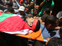 Palestinian mourners carry the body of Mohammed Majed Bakr, a 25-year-old fisherman who died from his injuries after an Israeli patrol vesse...
