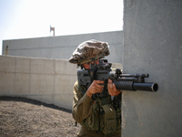 An Israeli soldier of the Golani Brigade takes part in an urban warfare drill at a mock village in the Elyakim army base, Northern Israel, M...