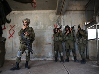 Israeli soldiers of the Golani Brigade take part in an urban warfare drill at a mock village in the Elyakim army base, Northern Israel, May...