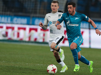 Giuliano (R) of FC Zenit St. Petersburg and Pavel Mamayev of FC Krasnodar vie for the ball during the Russian Football League match between...