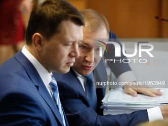 Viktor Yanukovych (not present) head of defence Vitalii Serdyuk (R) talk to his colleague before the court hearing. Obolon district court of...