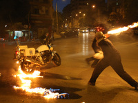 A police motorcycle on fire after being hit by a molotov coctail thrown by protesters during an anti-austerity demonstration during the disc...
