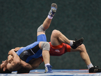 Magomed Muslimov of Azerbaijan competes against Jan Sadeed Malilk of Afganistan in the Mens Freestyle Wrestling 65kg semi-finals during day...