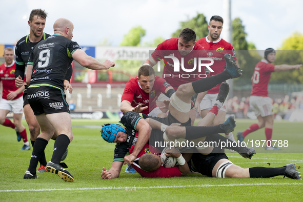 Simon Zebo of Munster with the ball tackled by Justin Tipuric of Ospreys during the Guinness PRO12 Semi-Final match between Munster Rugby an...