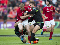 Keith Earls of Munster tackled by Ashley Beck of Ospreys during the Guinness PRO12 Semi-Final match between Munster Rugby and Ospreys at Tho...