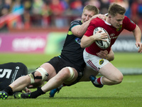 Rory Scannell of Munster tackled by Bradley Davies of Ospreys during the Guinness PRO12 Semi-Final match between Munster Rugby and Ospreys a...