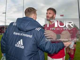 Jaco Taute of Munster and his teammate John Ryan during the Guinness PRO12 Semi-Final match between Munster Rugby and Ospreys at Thomond Par...