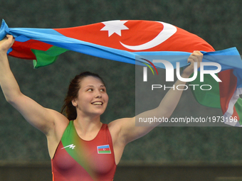 Tetiana Omelchenko of Azerbaijan celebrates after winning against Nur Adakan Gamze of Turkey in the Women's Freestyle 60kg Wrestling final d...