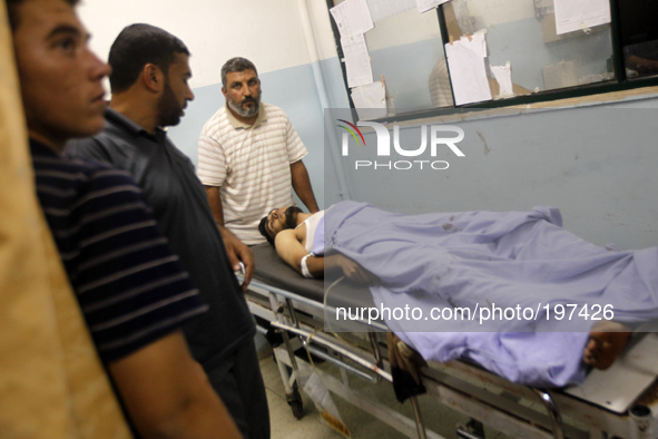 A Palestinian man, who was wounded in an Israeli strike, arrives at a hospital in Khan Yunis in the southern Gaza Strip on July 30, 2014. Is...