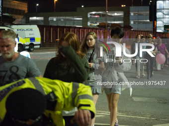 People, believed to be leaving the Manchester Arena, after an explosion after the Ariana Grande concert which took place on 05/22/2017 at Ma...