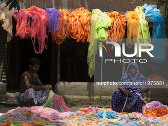 People process waste cloths to make them usable in Dhaka, Bangladesh on May 23, 2017. (