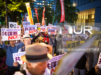 Protesters shout slogans denouncing a pending anti-conspiracy bill during a rally in front of the National Diet building in Tokyo May 23, 20...