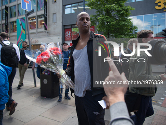 A person arrives at the police cordon to drop flowers off, for the victims of the Manchester Arena explosion, in Manchester, United Kingdom...