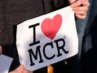 People hold up signs which say 'Turn to Love for Manchester' during a vigil for the victims of yesterday's Manchester Arena terror attack in...