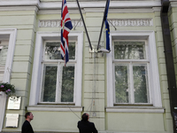 Employees of the British Embassy in Kiev, Ukraine fly a flag at half-mast, Tuesday, May 23, 2017. An apparent suicide bomber attacked an Ari...