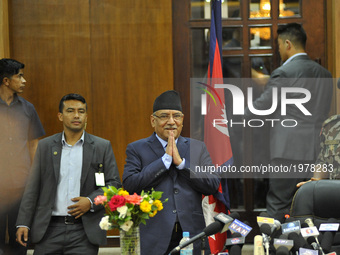 Prime Minister of Nepal, Pushpa Kamal Dahal, greets people as arrives to resigns after addressing the nation from his office at Singh Durbar...
