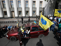 Dozens of people block the street near Ukrainian parliament Verkhovna Rada by their vehicles, brought in Ukraine from EU countries, demandin...