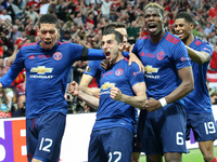 Henrikh Mkhitaryan (C) of Manchester United celebrates scoring the second goal to make the score 0-2 with team-mate Paul Pogba (R) and Chris...