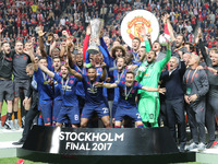 Manchester United's team celebrate with the trophy after they won the UEFA Europa League Final match between Ajax and Manchester United at F...