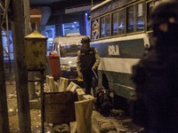 Police officers search for dangerous material in the site of bomb exploison at Kampung Melayu bus station, Jakarta, Indonesia, on May 24, 20...